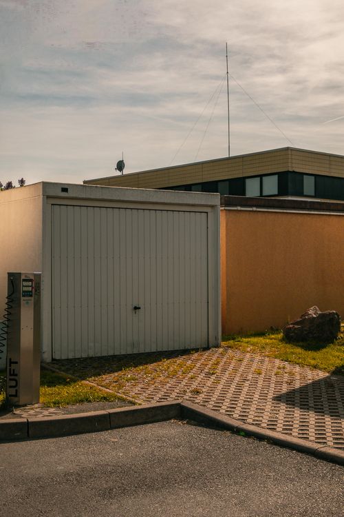 Minimalist closed garage with clean paving stones.