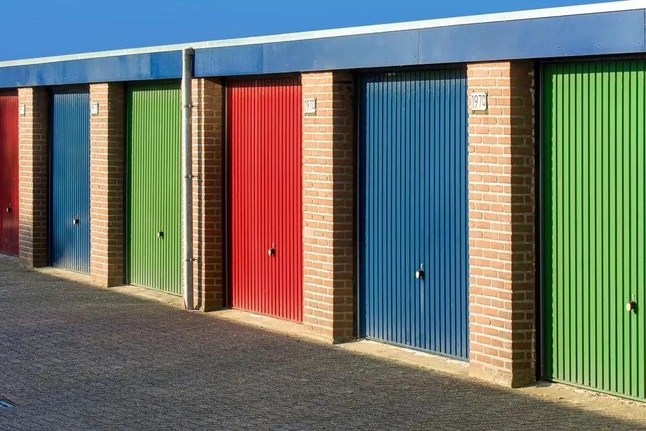 Vibrant urban scene showcasing colorful garage doors aligned in a row under clear skies.