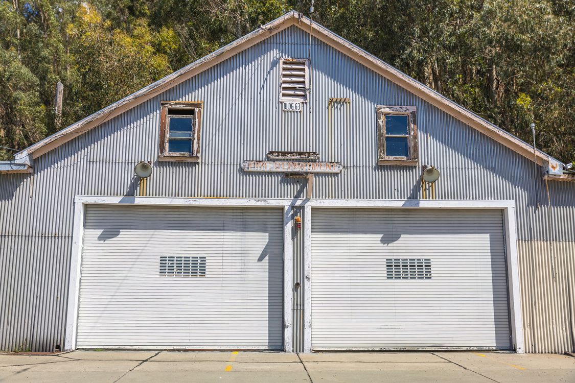 Vintage metal garage with double doors and rustic charm.